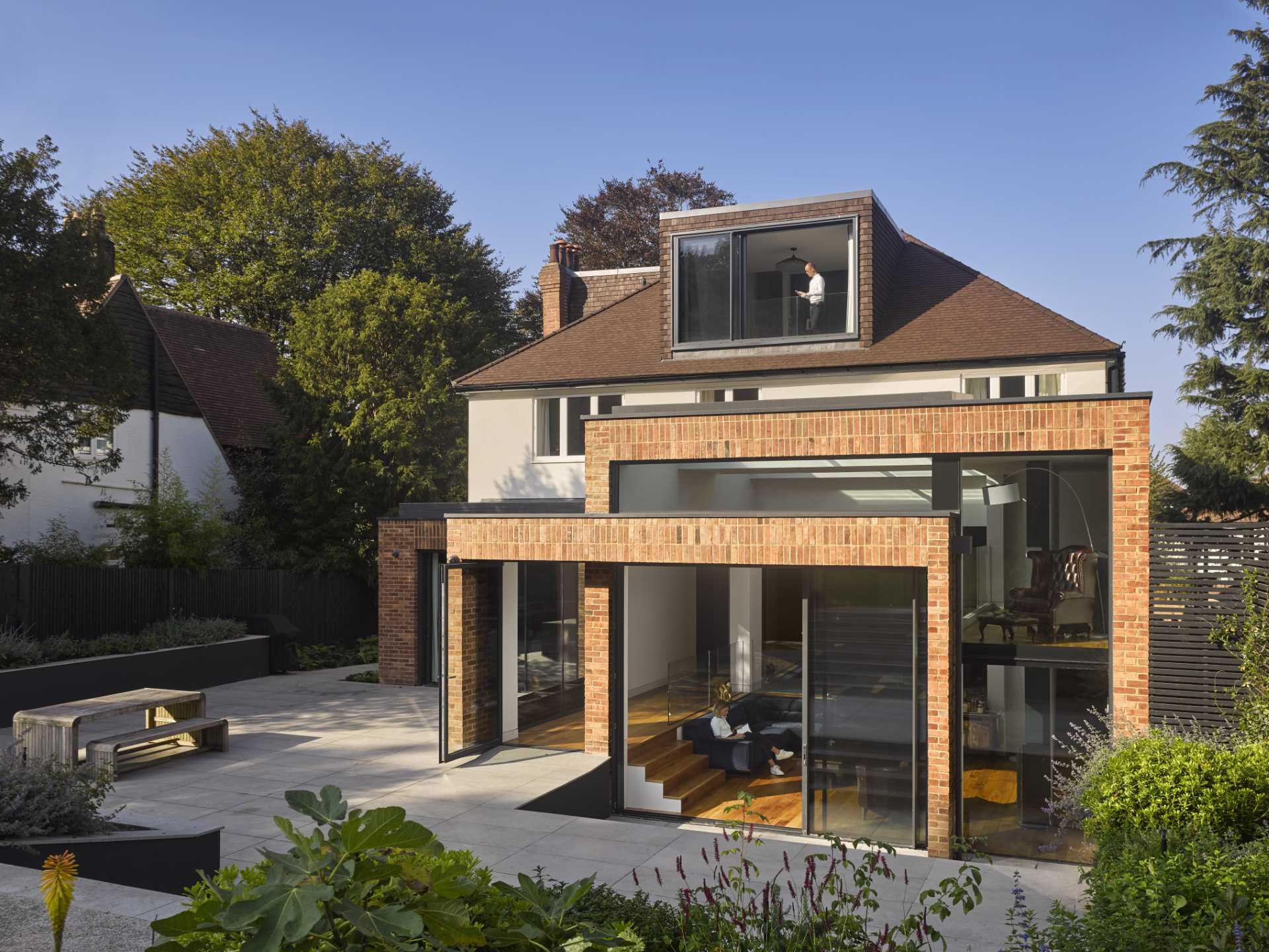 A 1920s British home received a modern rear addition with a sunken living room.