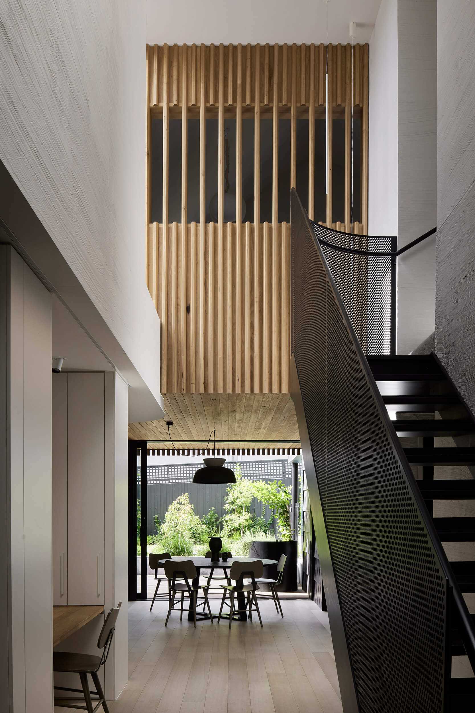 A modern open plan dining area with a round table.