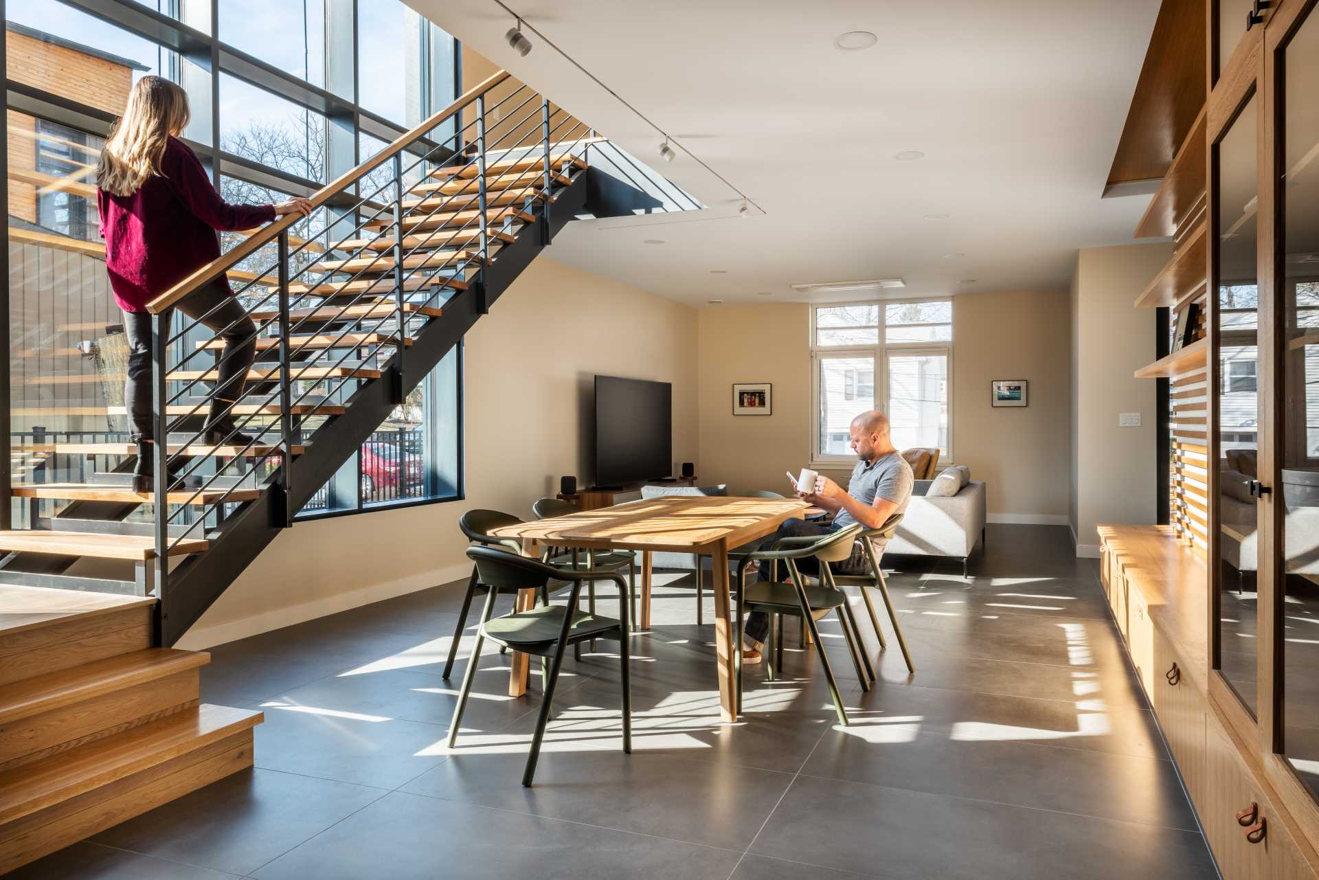 A modern home with an open-plan interior with concrete floor.