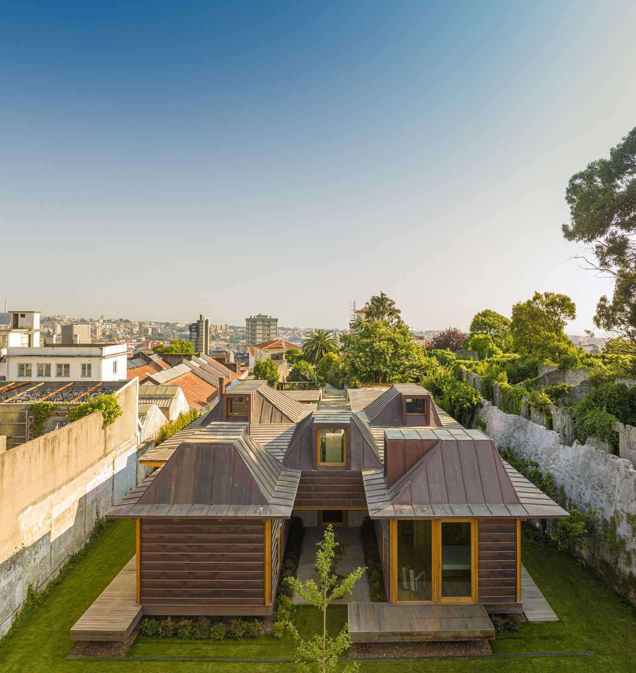 A modern house with copper-clad roof and copper siding, and wood framing.