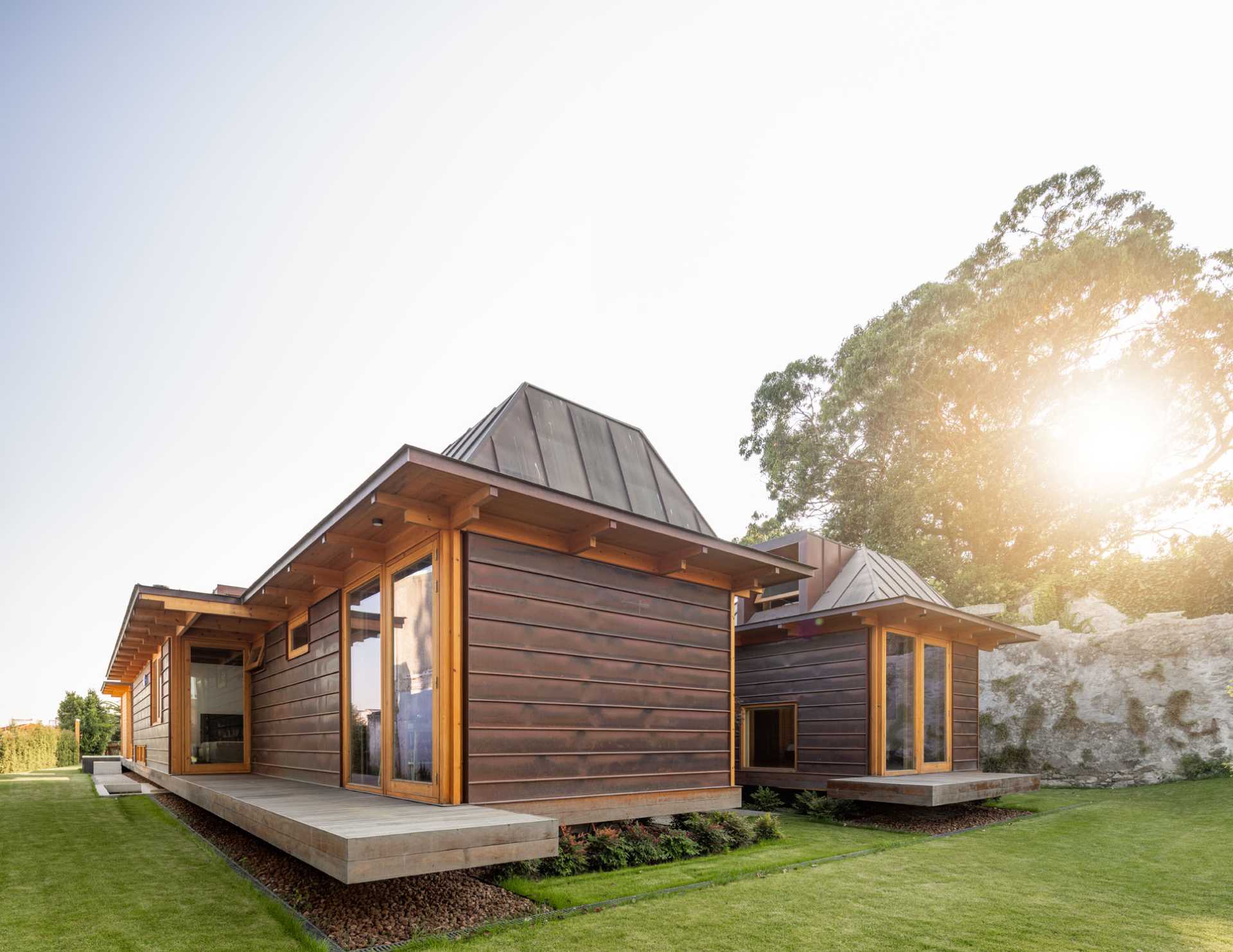 A modern house with copper-clad roof and copper siding, and wood framing.