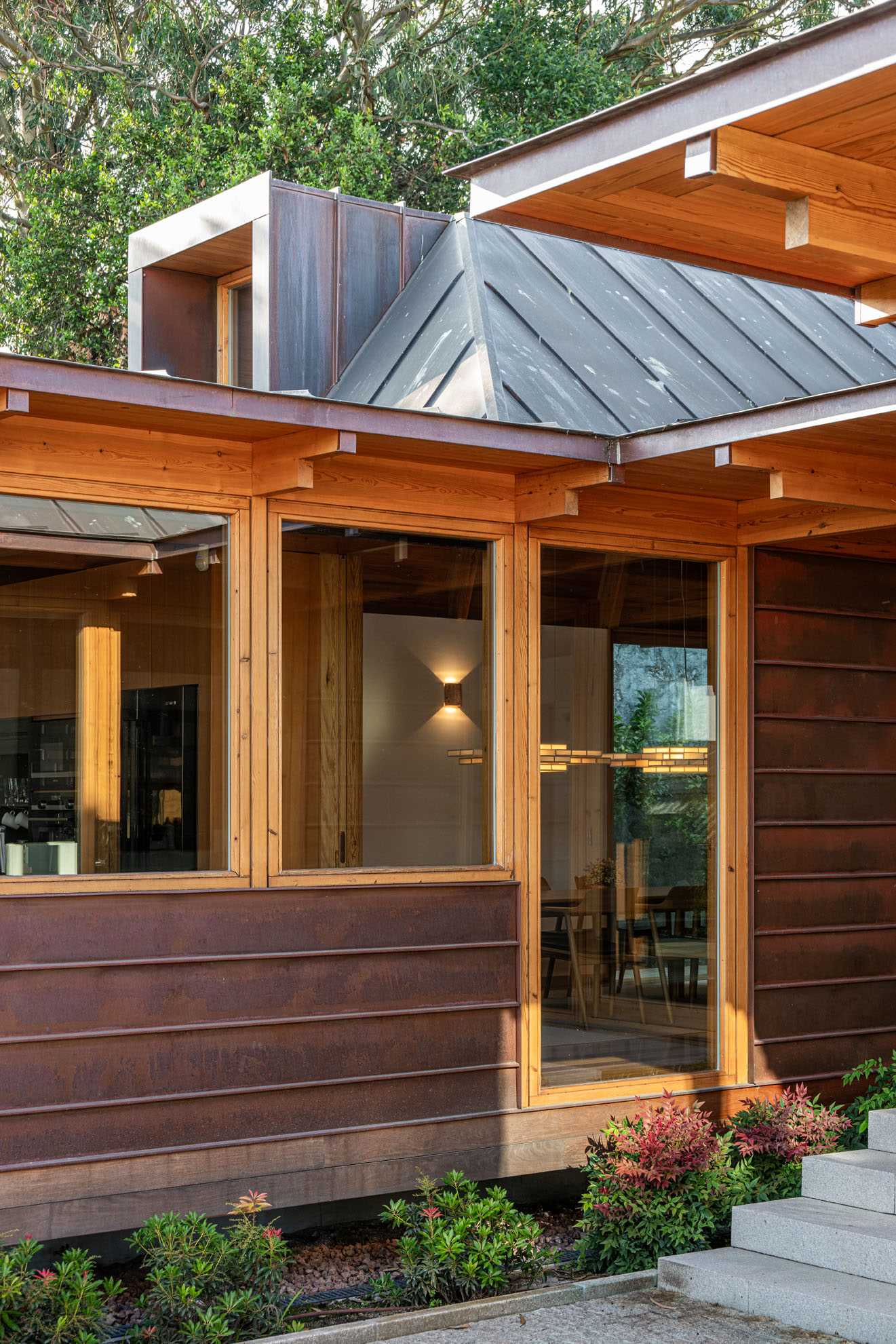 A modern house with copper-clad roof and copper siding, and wood framing.