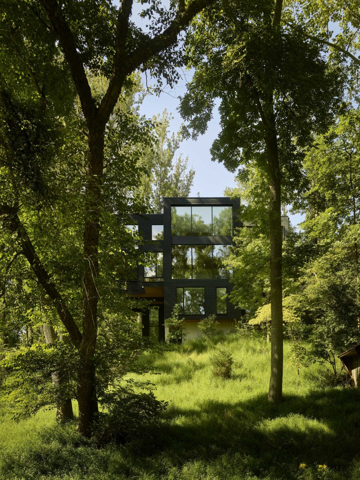 A Dark Exterior Helps To Hide This Modern Home In The Forest