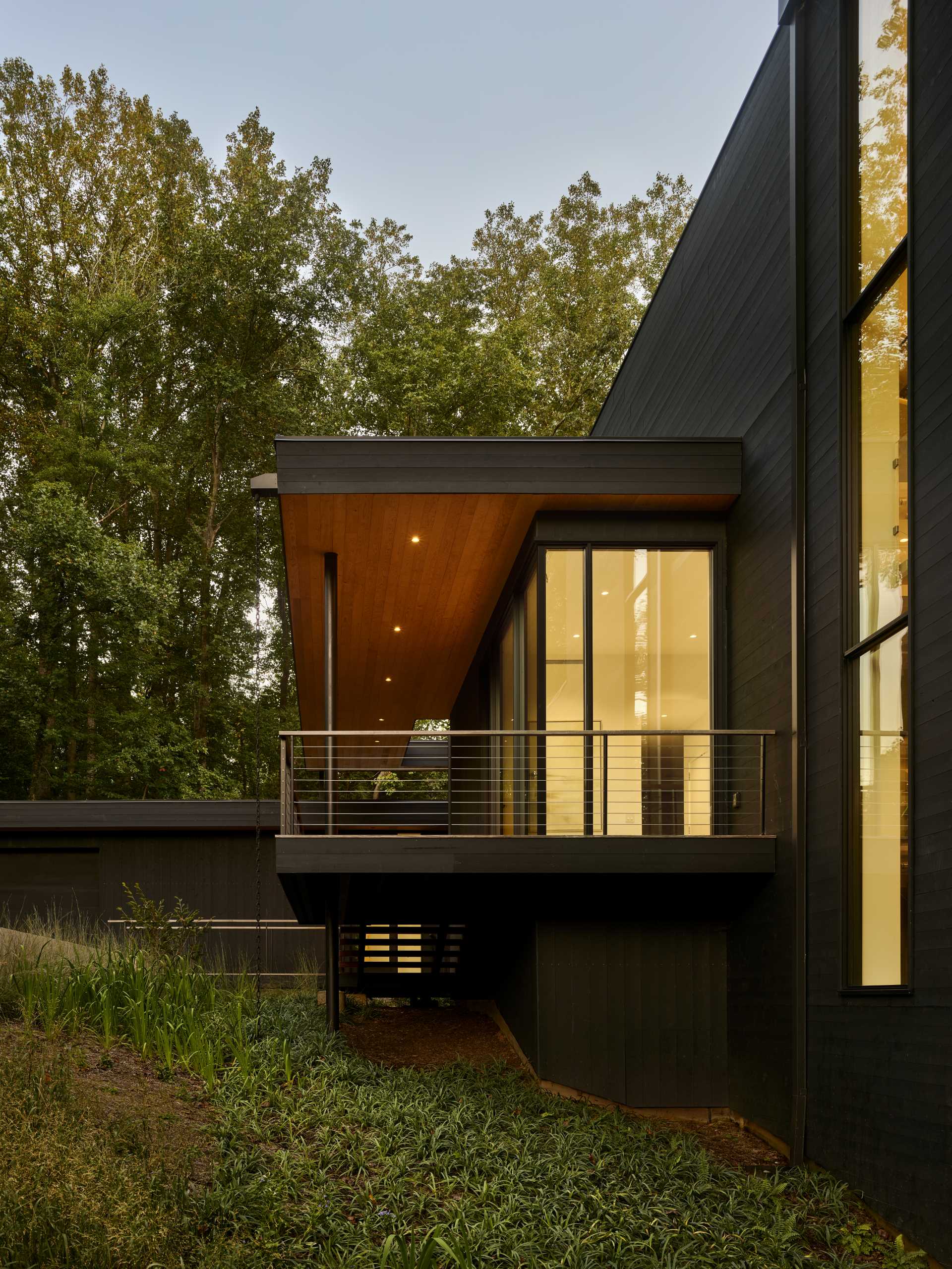 A modern home with a covered walkway to the front door.