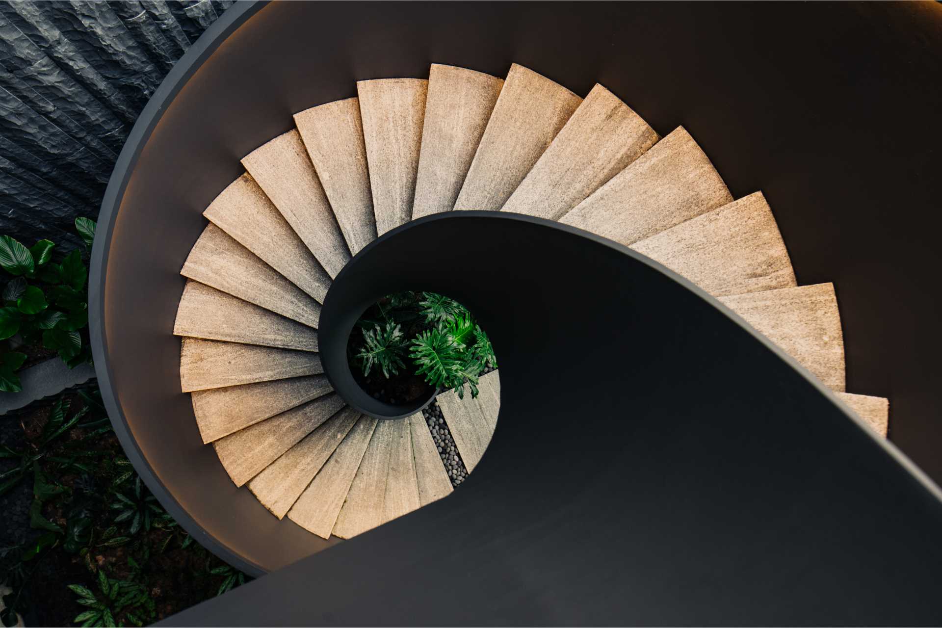 A modern home with external spiral stairs.