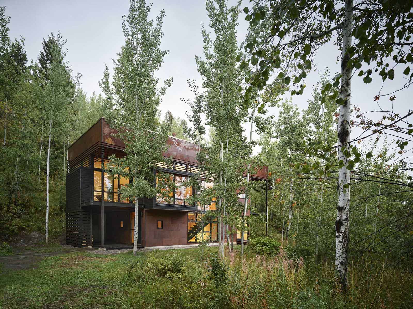 This modern two-storey home incorporates slow-weathering materials such as oxidized steel and cedar, allowing the home to change appearance over time.