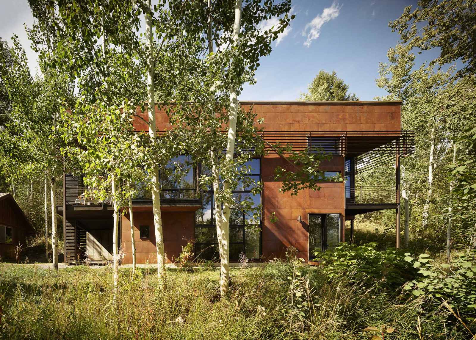 This modern two-storey home incorporates slow-weathering materials such as oxidized steel and cedar, allowing the home to change appearance over time.