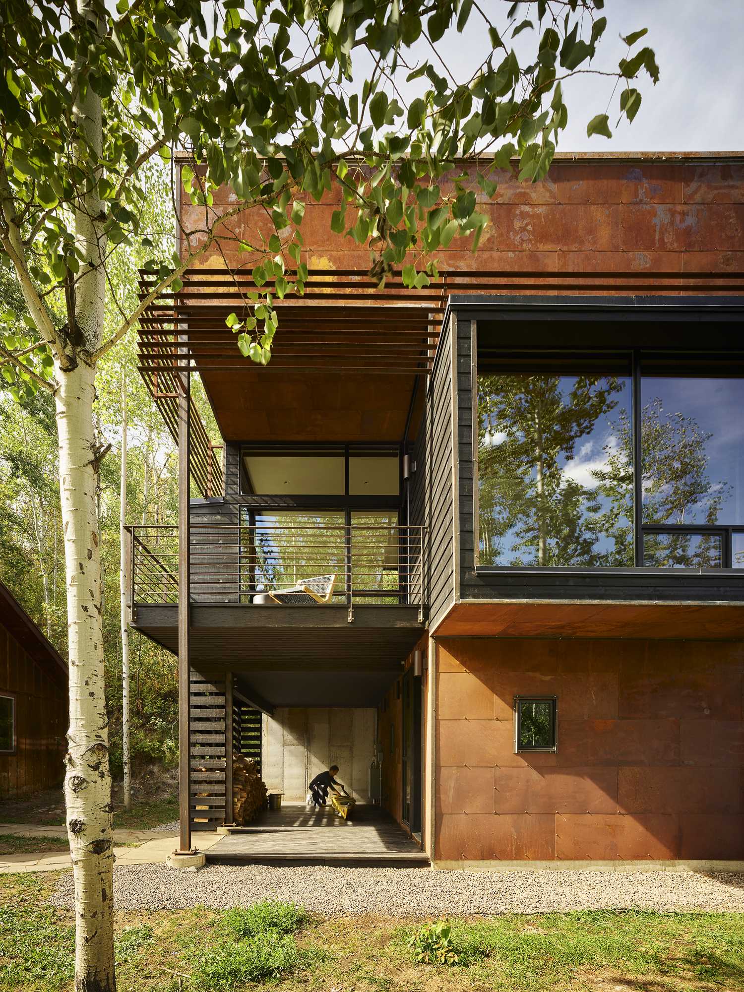 A cantilevered, cedar-clad projection from the second level expands the living spaces inside and adds visual interest to the exterior of the home.