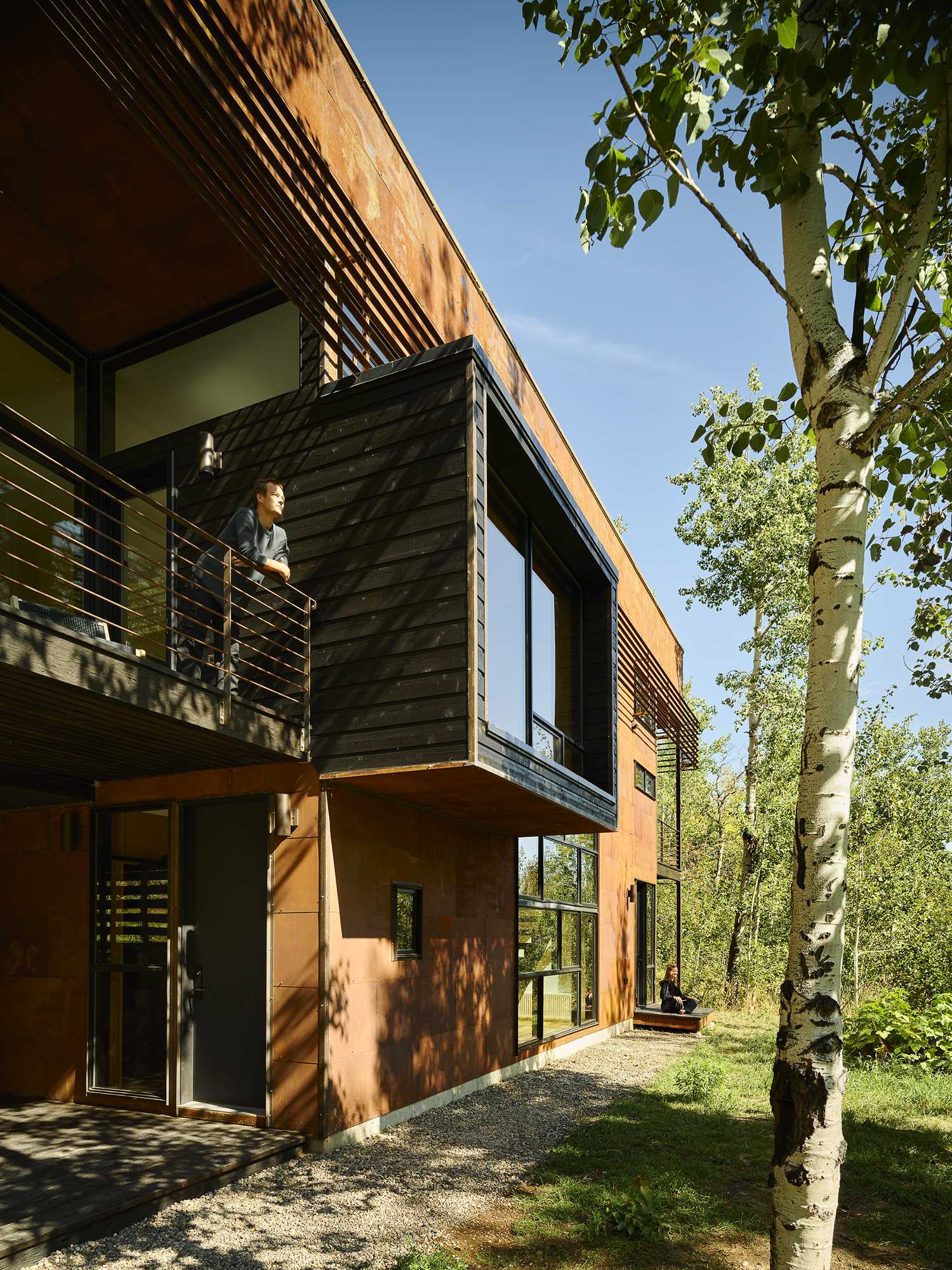 A cantilevered, cedar-clad projection from the second level expands the living spaces inside and adds visual interest to the exterior of the home.