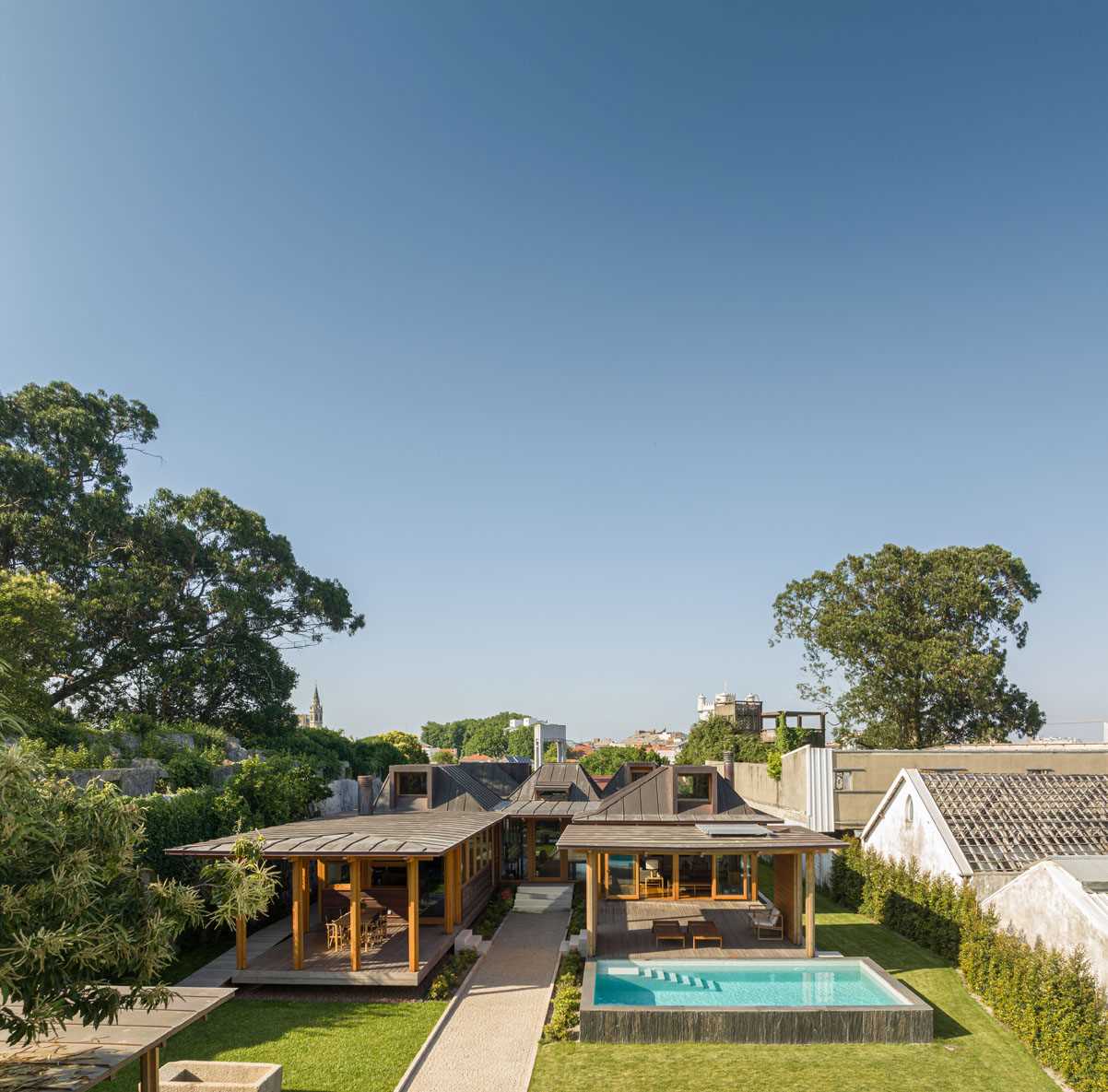 A modern house with copper-clad roof and copper siding, and wood framing.