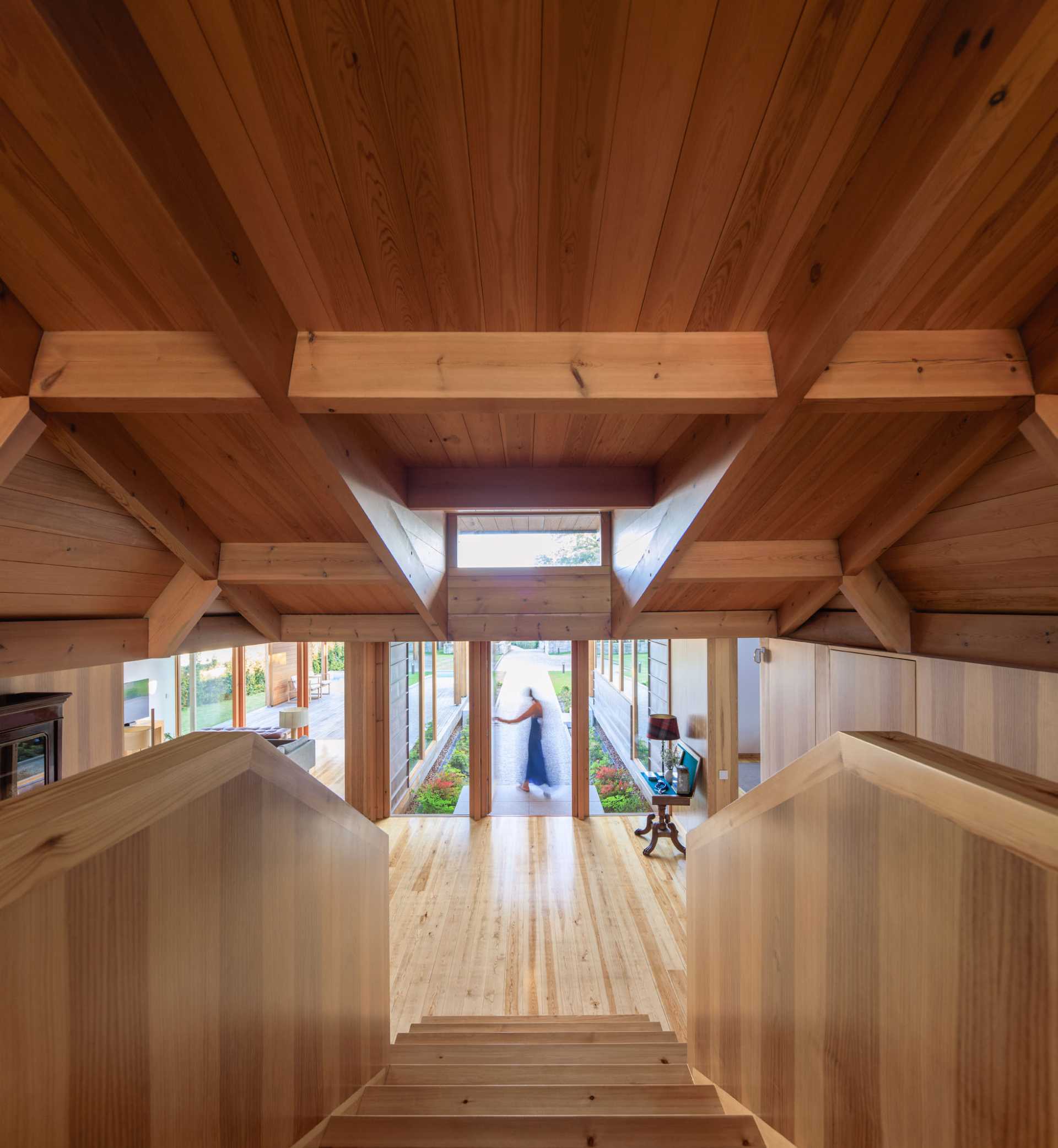 A modern house with wood walls, stairs, ceiling, and floor.