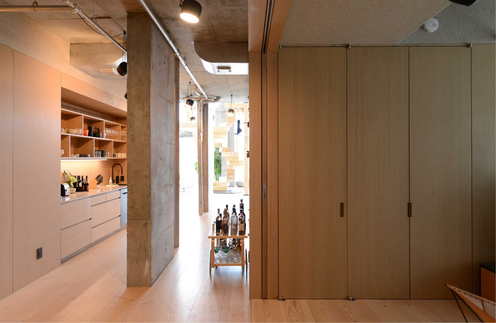 A hallway includes a wet bar.