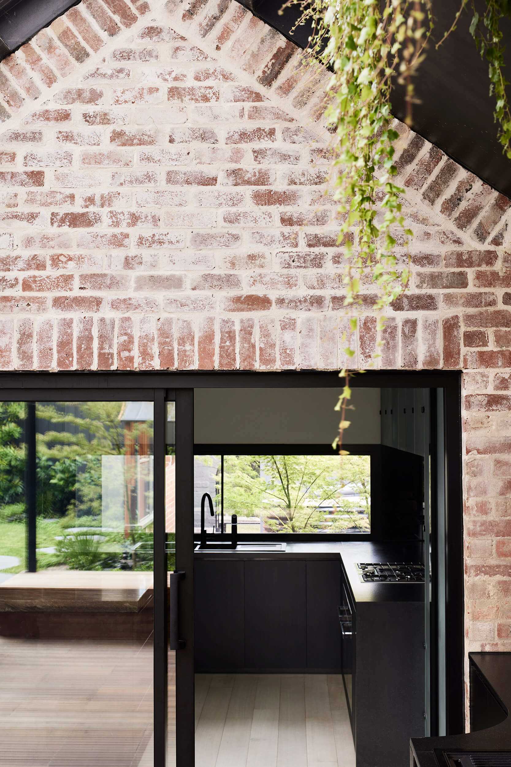 In the kitchen, dark cabinets, countertops, lighting, and painted brick wall, all assist in creating a bold appearance.