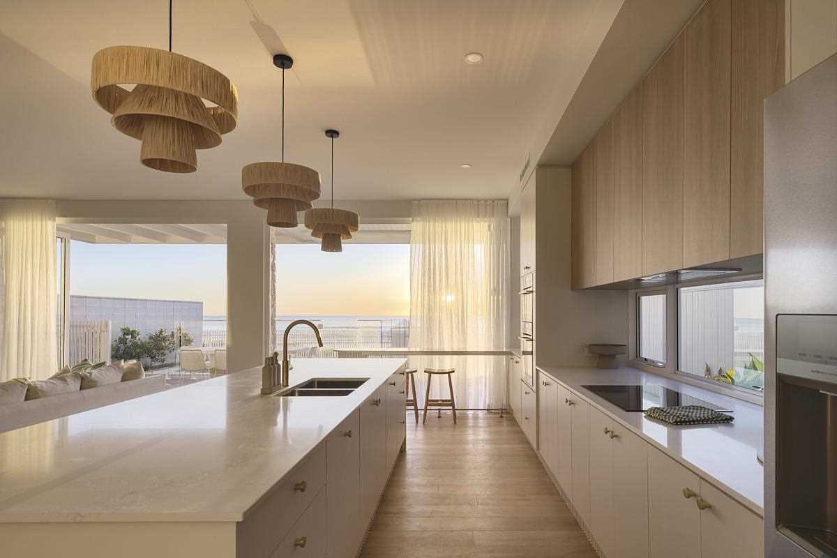 A modern coastal-inspired kitchen with a large island.