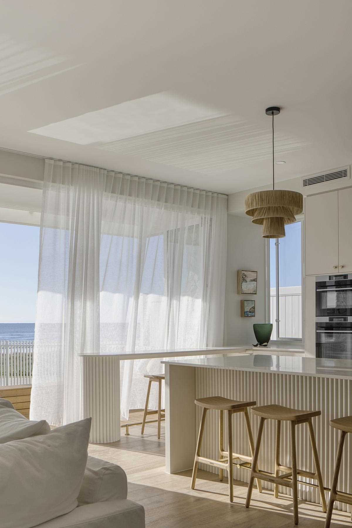 A modern coastal-inspired kitchen with a large island.