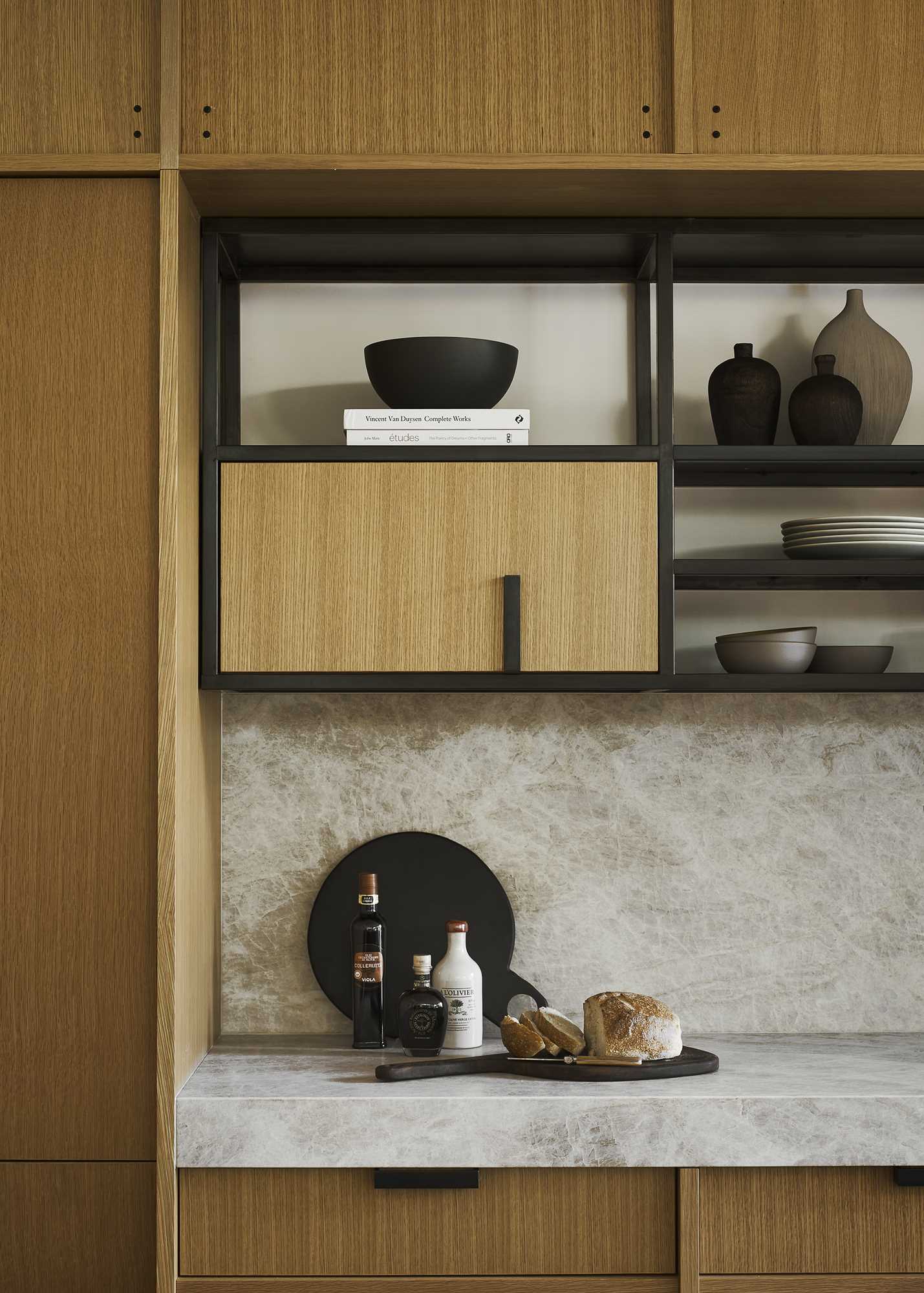 A modern kitchen with white oak cabinets and black accents.