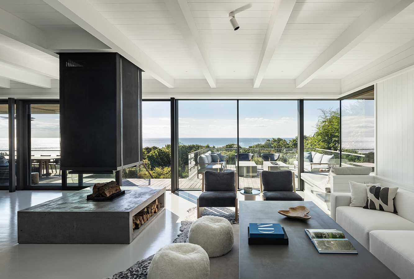 A modern living room with white painted wood creates a casual environment for the beach location.