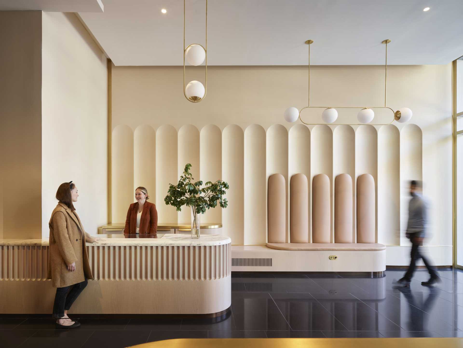 A contemporary lobby in an office building with arched geometry.