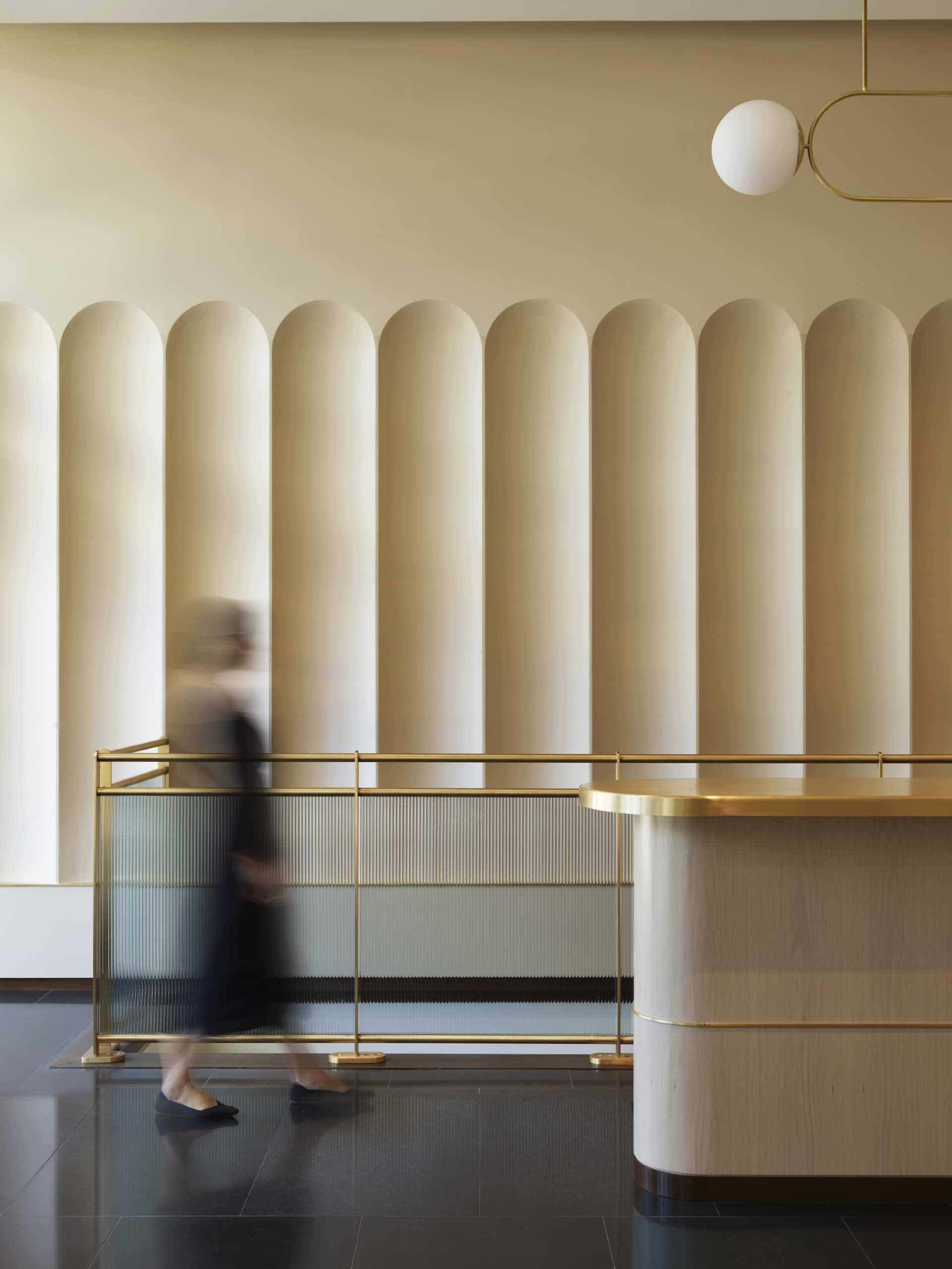 A contemporary lobby in an office building with arched geometry.