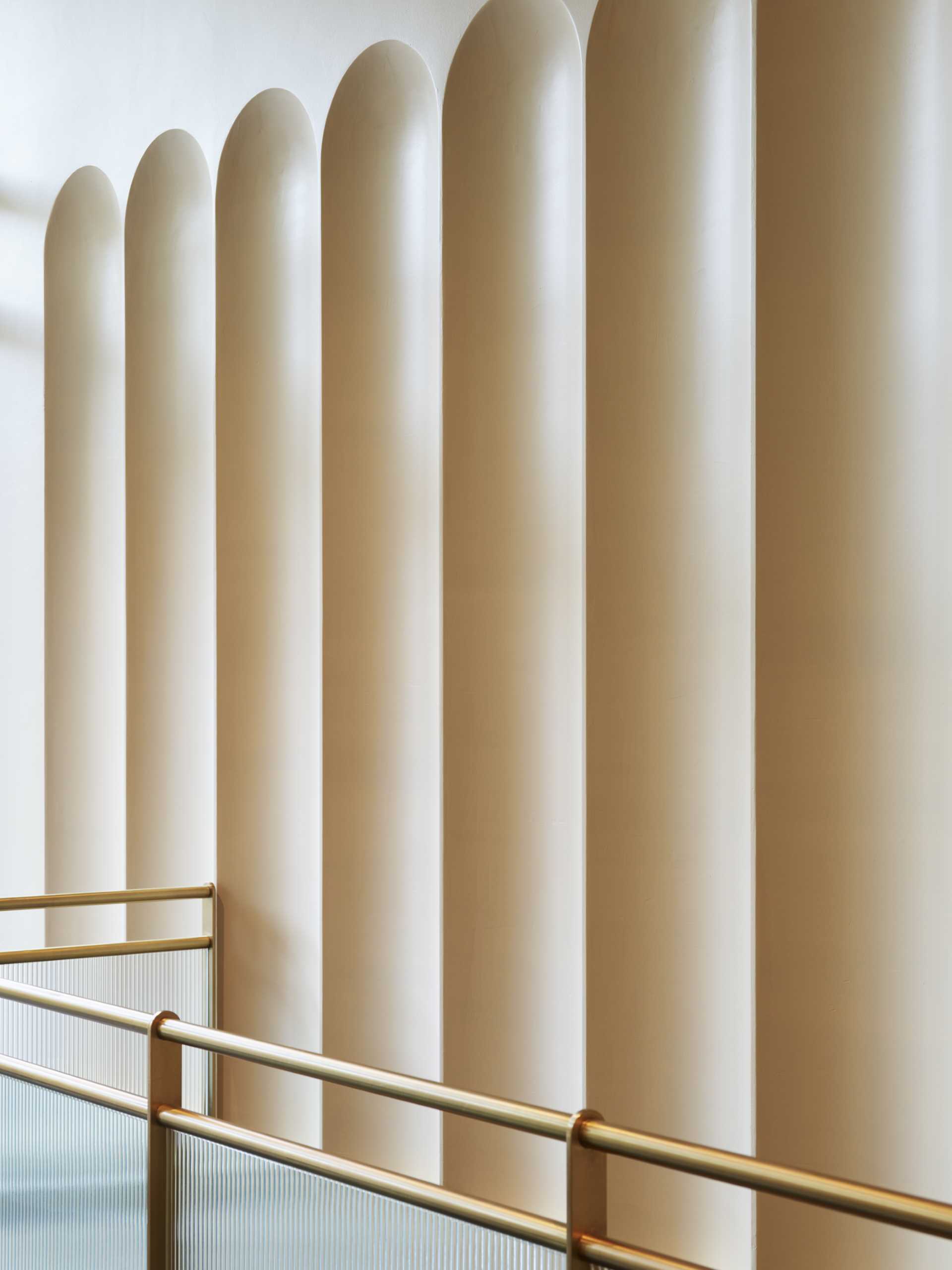 A contemporary lobby in an office building with arched geometry.