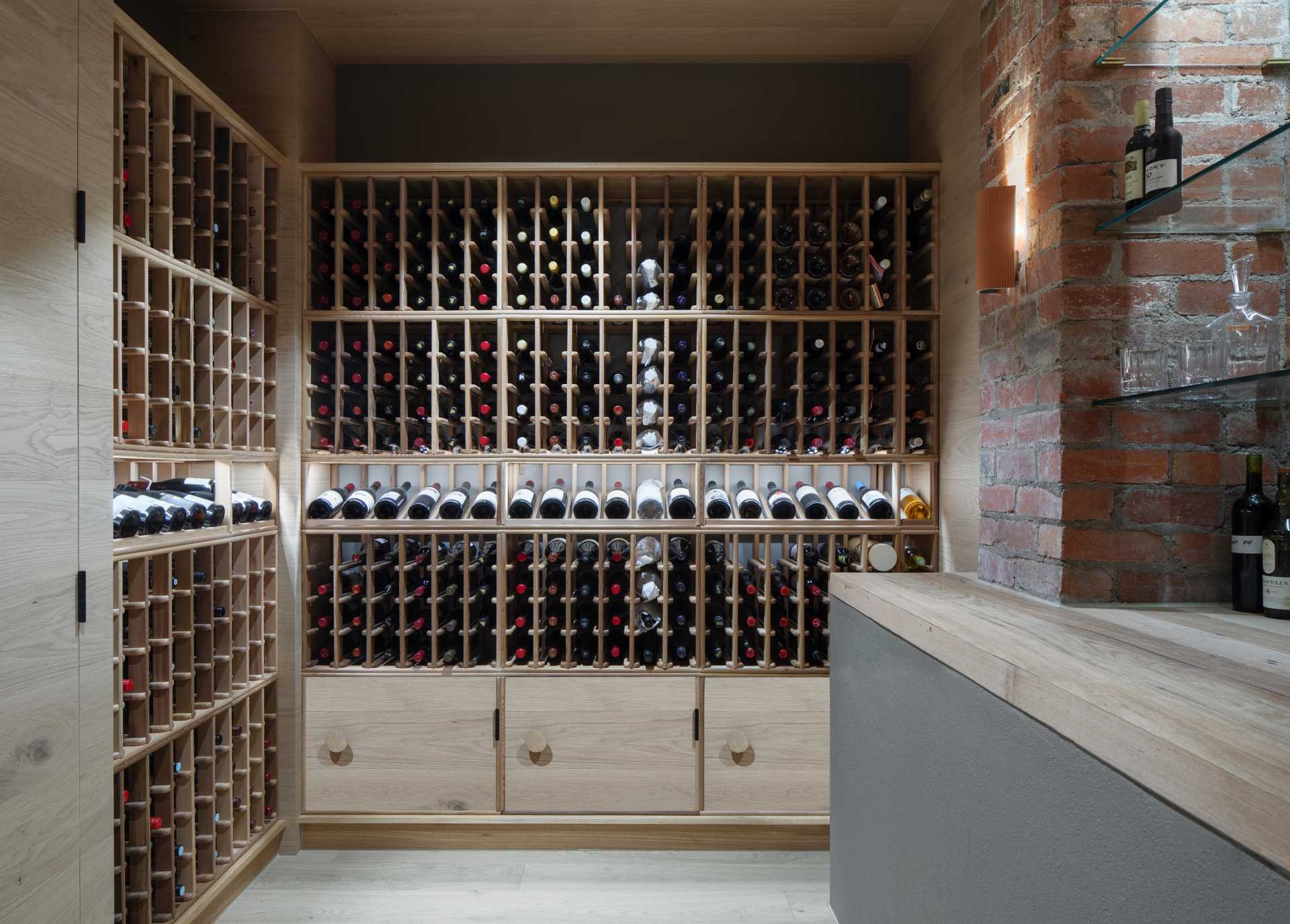 A basement wine cellar with custom shelving and cabinetry.