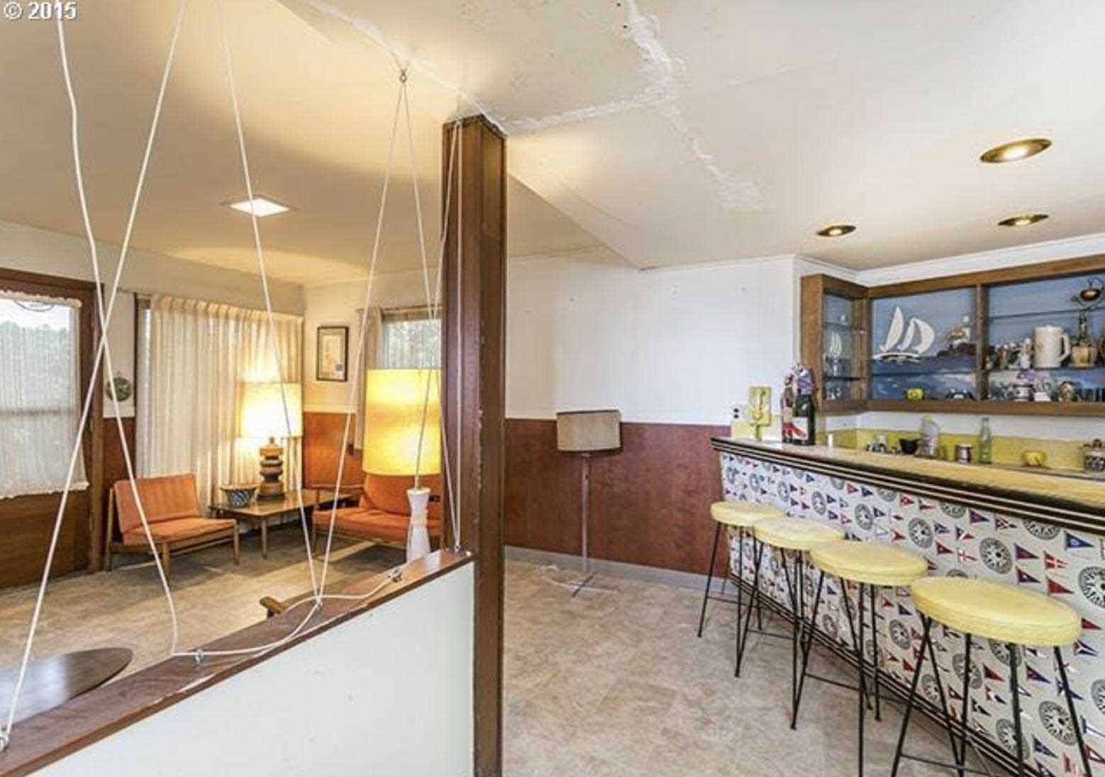 Before - The original bar area includes yellow and black stools that match the yellow countertop.