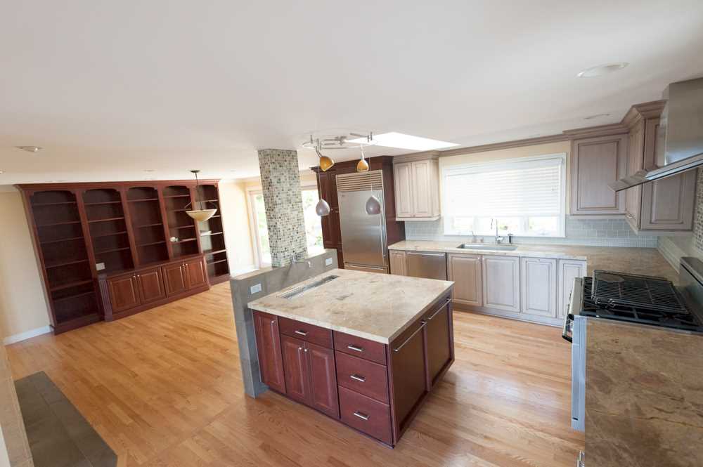 BEFORE - The original dining and kitchen area had a combination of dark and light wood cabinets.