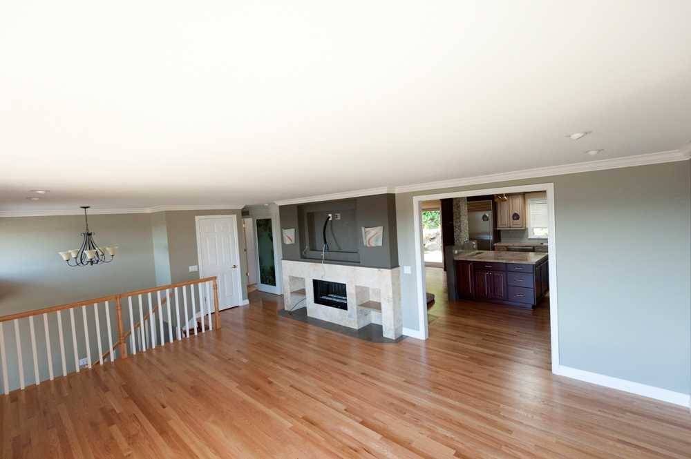 BEFORE - The original living room was separated from the kitchen and dining room.