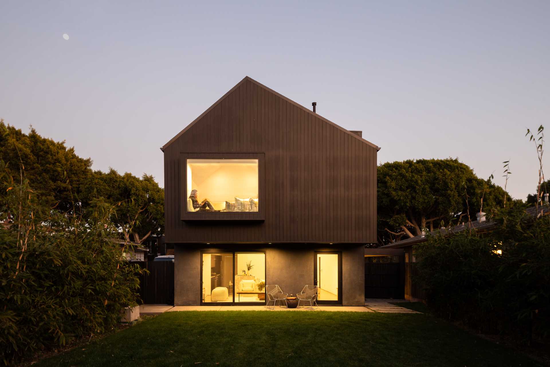 A modern barn-inspired home with a black exterior and bright white interior.