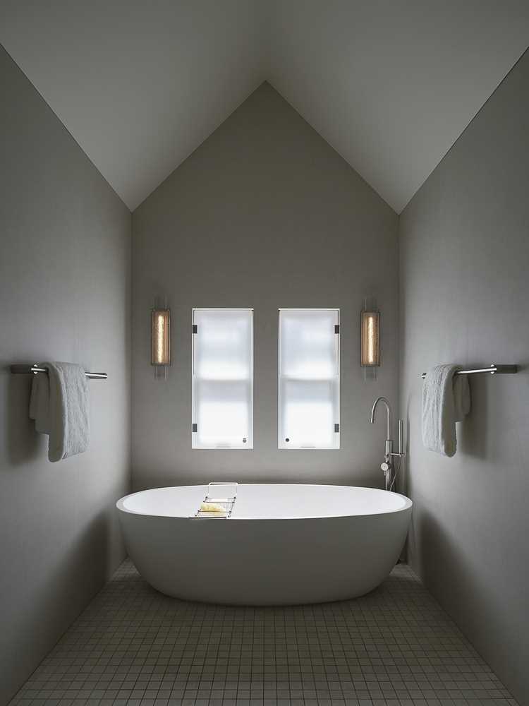 A bathroom with a cathedral ceiling.