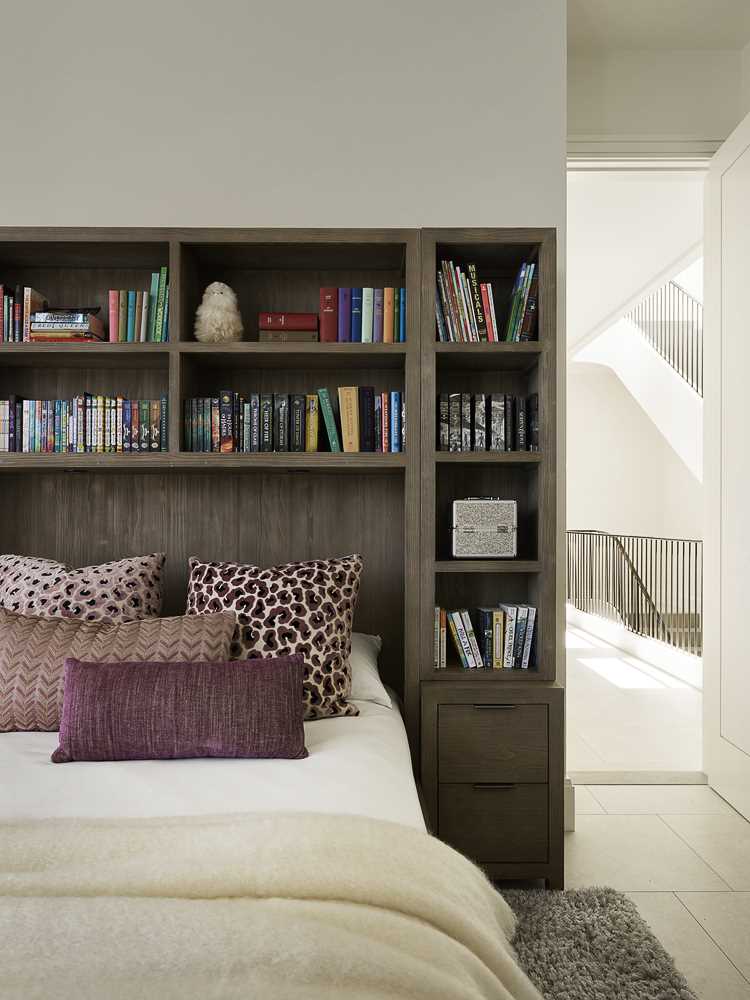 In this bedroom, there's a dark wood bed frame and headboard that contrast the light walls, while the view becomes the focal point.