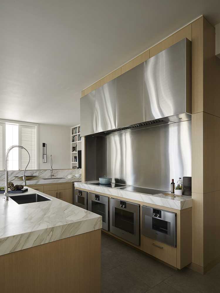 This kitchen combines stainless steel elements with wood cabinets for a contemporary look.