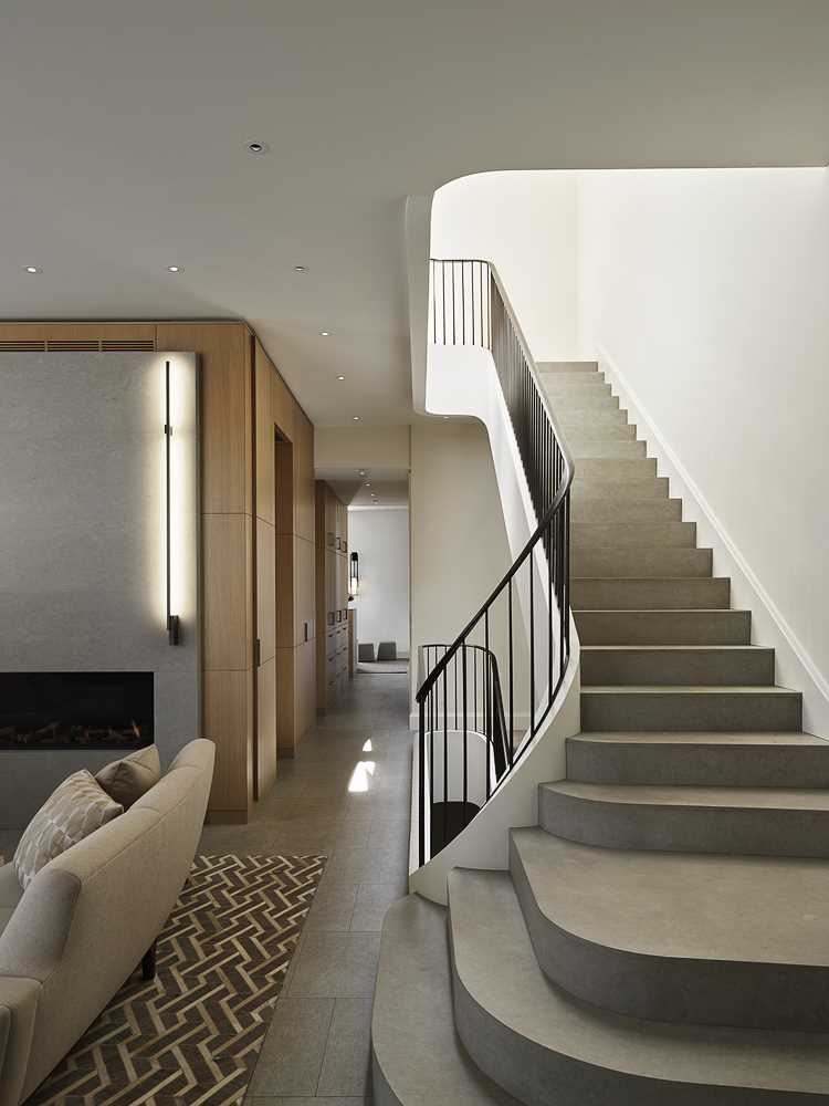 A contemporary staircase with a metal railing connects the four floors of this home.