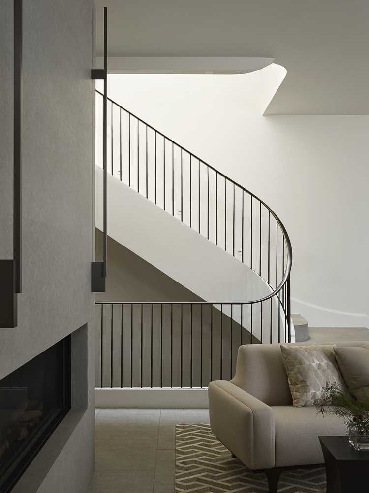 A contemporary staircase with a metal railing connects the four floors of this home.