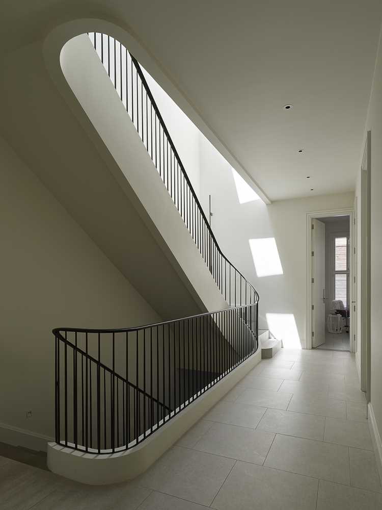 A contemporary staircase with a metal railing connects the four floors of this home.