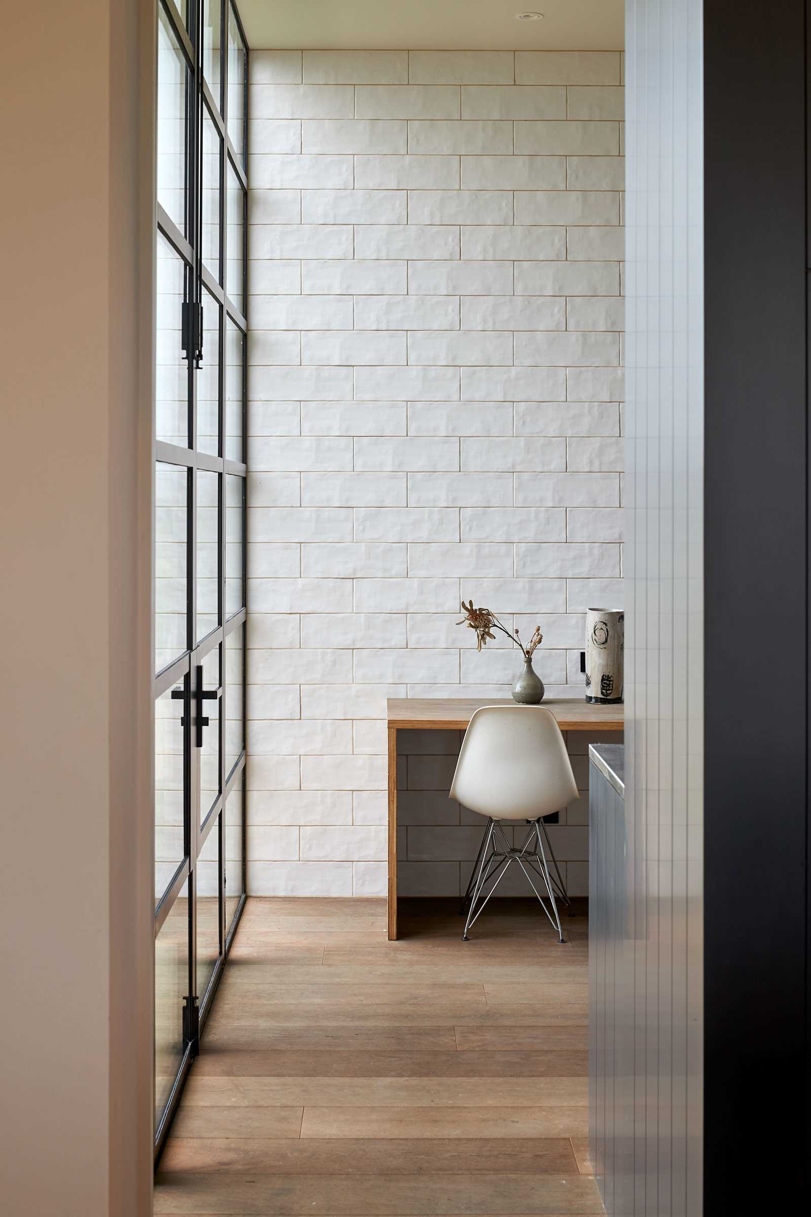 A modern farmhouse with a home office behind the kitchen.