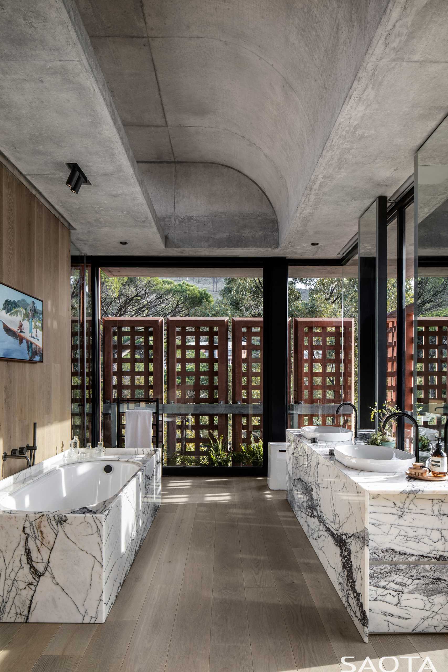 In this bathroom, the curved ceiling adds visual interest to the space, while the vanity matches the bathtub surround.