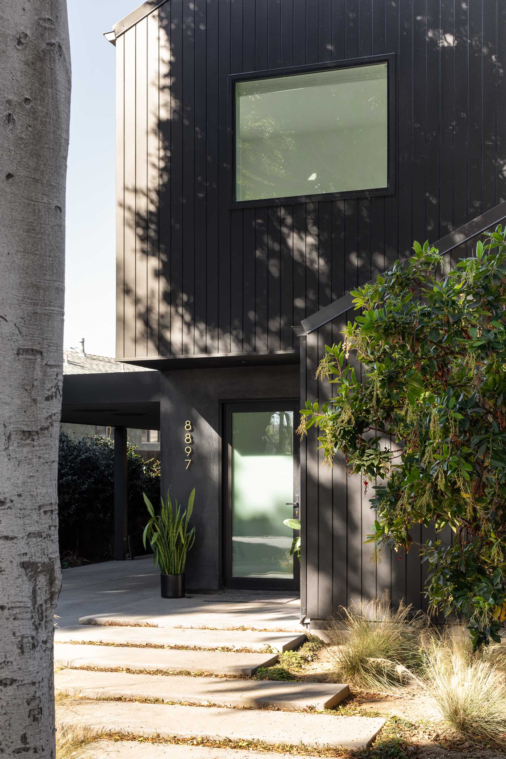 A modern barn-inspired home with a black exterior and bright white interior.