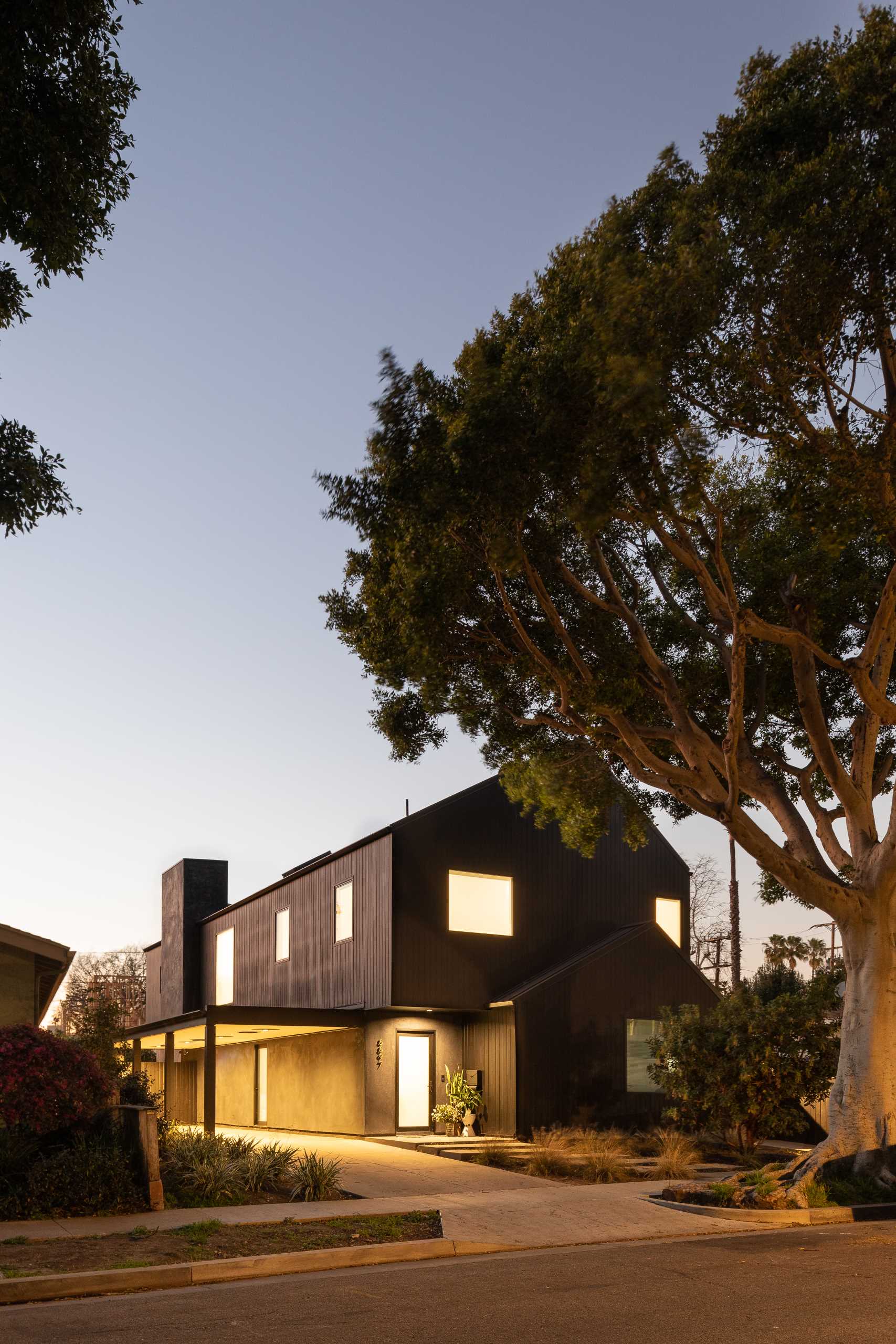 A modern barn-inspired home with a black exterior and bright white interior.