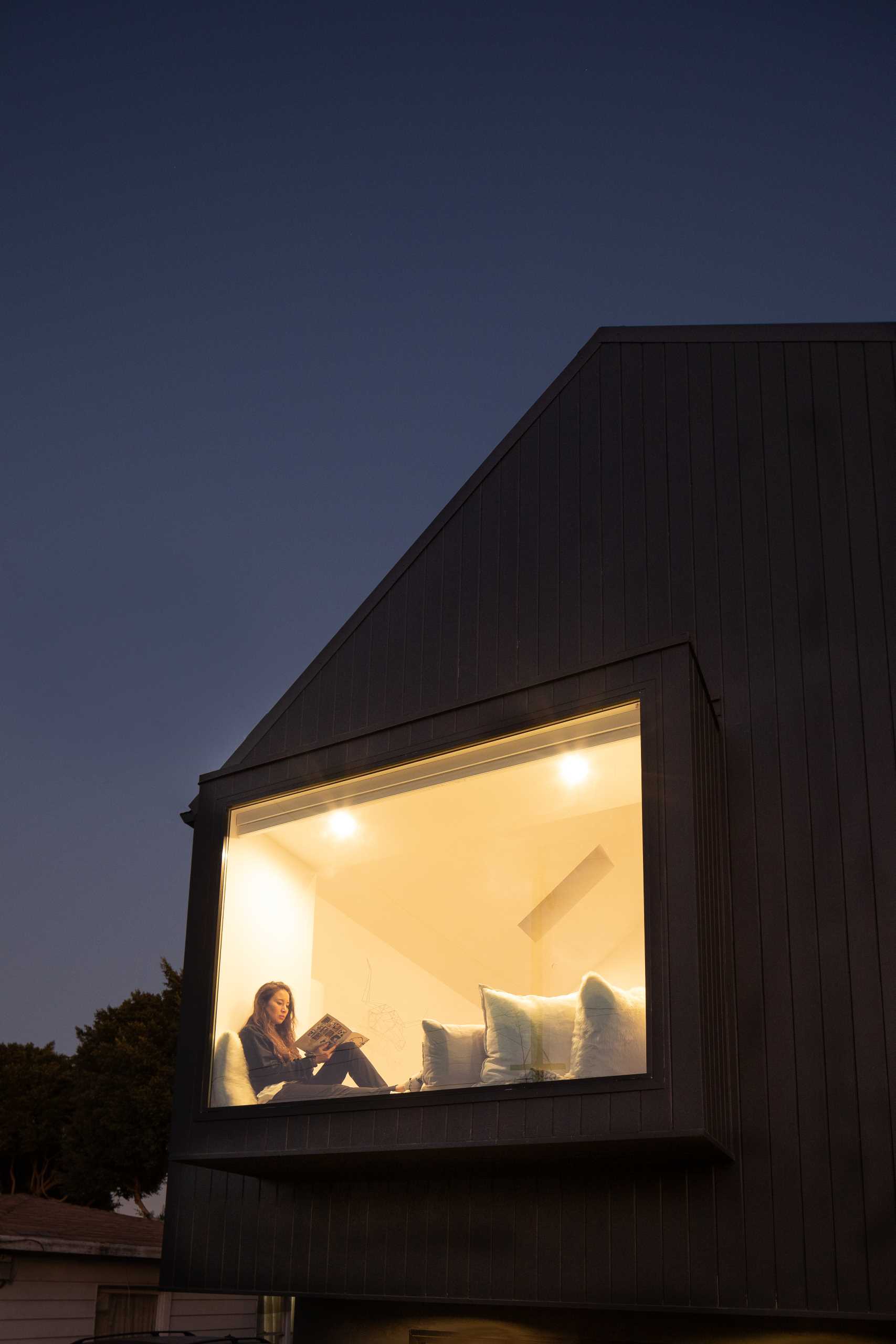 A modern barn-inspired home with a black exterior and bright white interior.