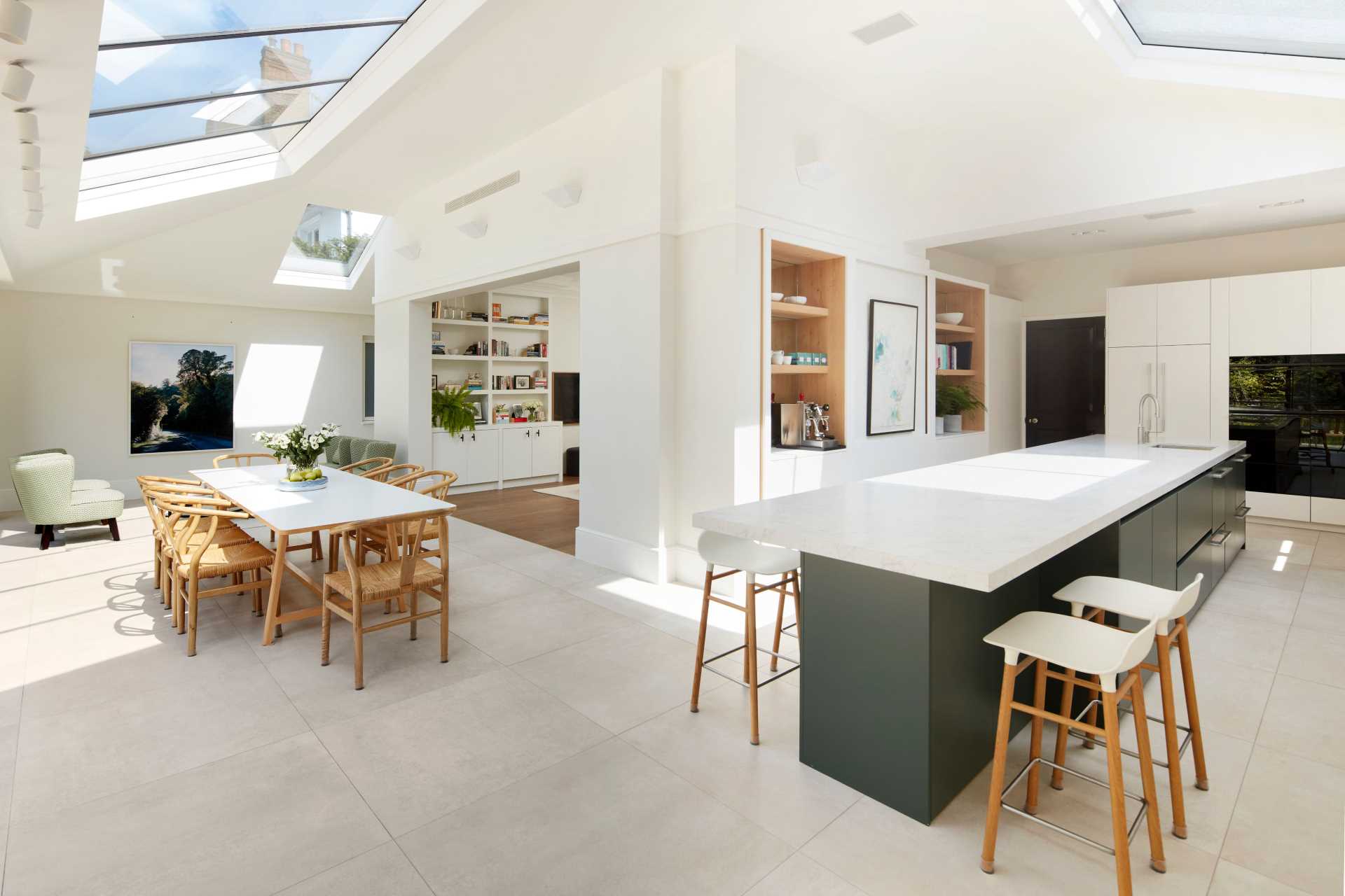 An updated brick extension for an Edwardian home includes a sitting area, dining area, and kitchen.