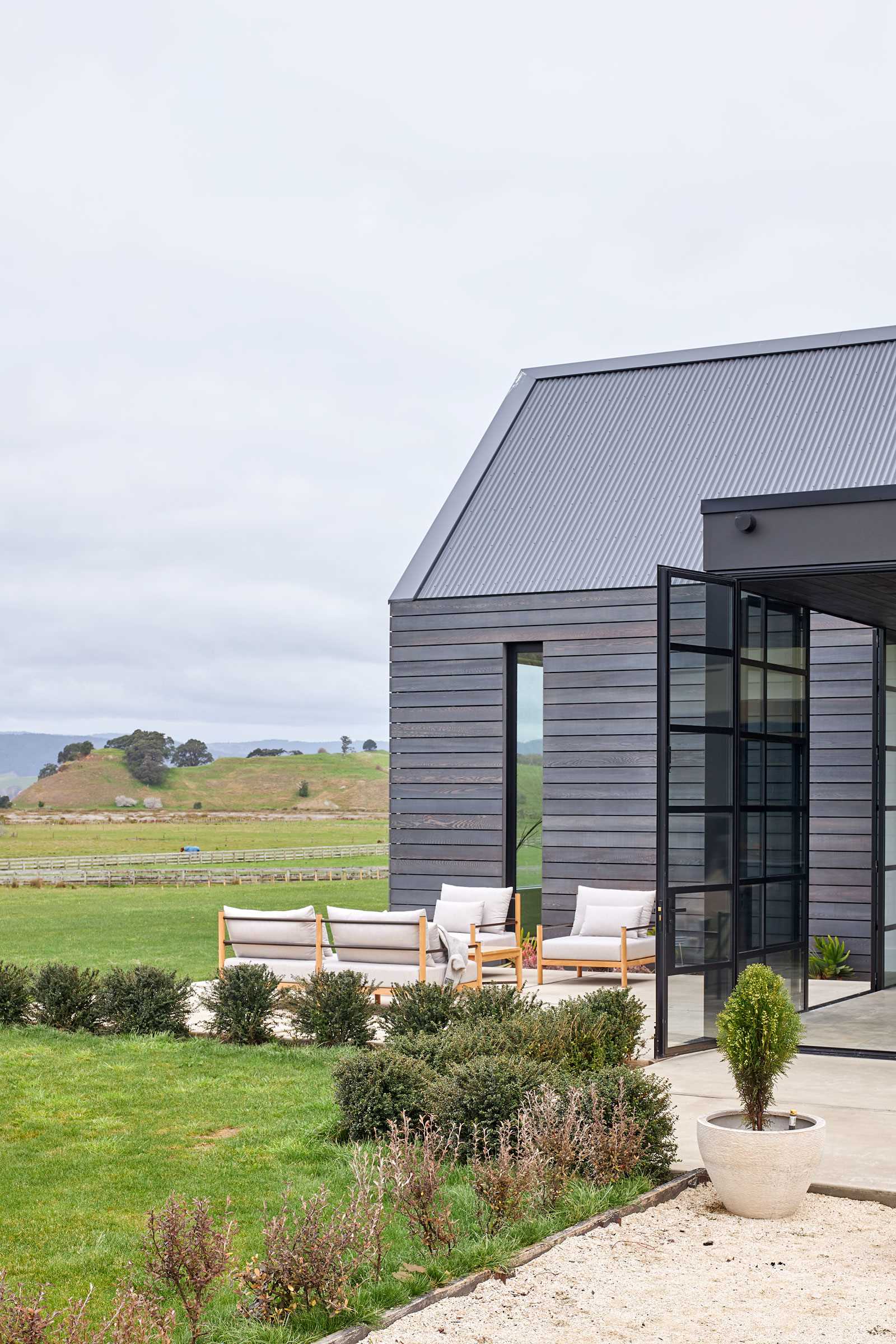 A patio with light-colored furnishings creates a place to relax and enjoy the view.