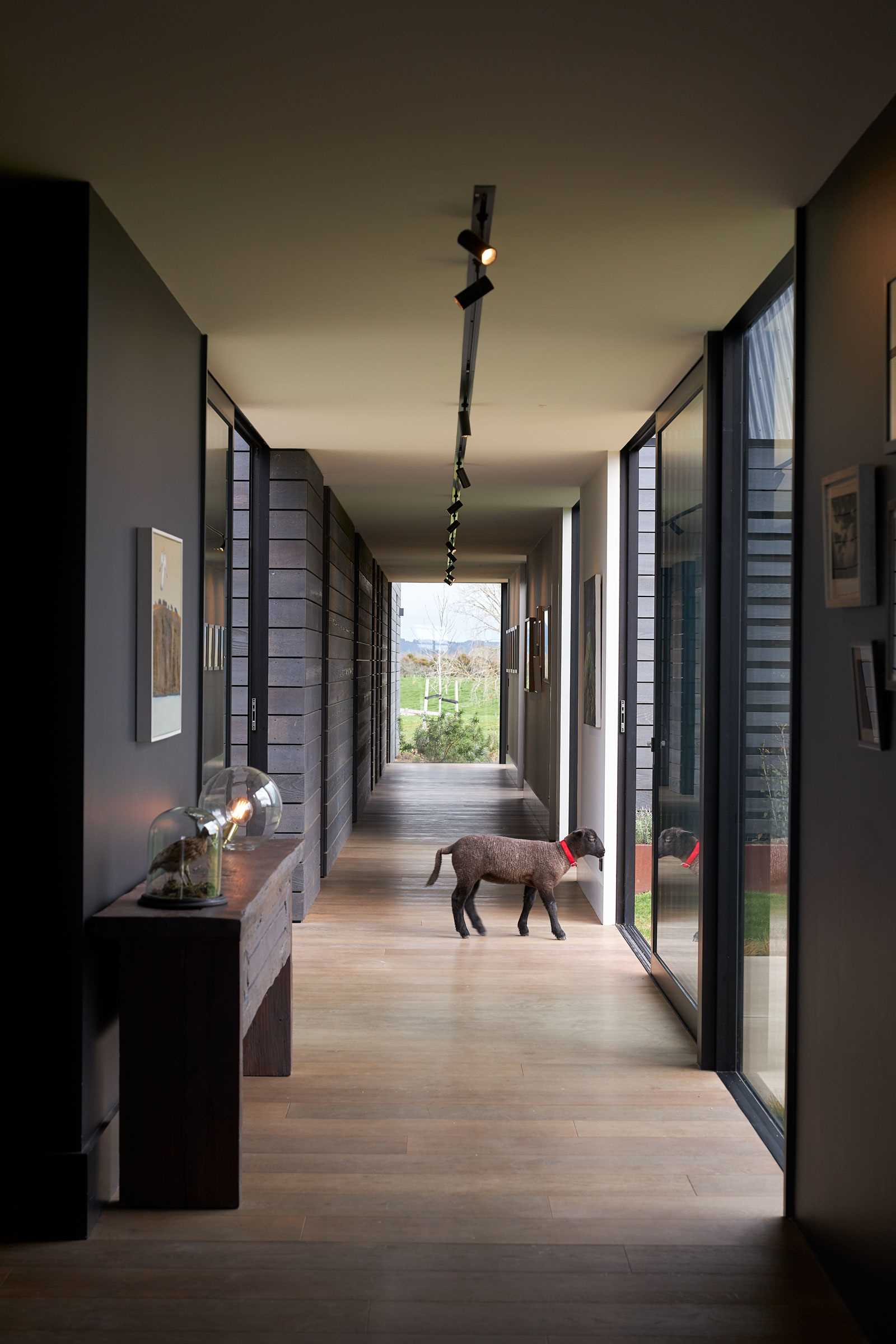 A hallway with wood floors connects the various spaces of the home.
