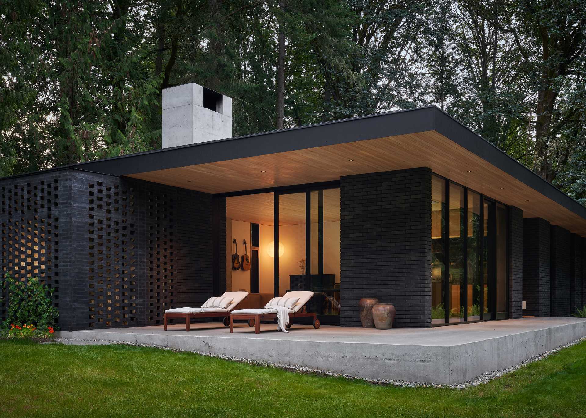 A modern home with a dark brick exterior and wood elements made from Douglas Fir.