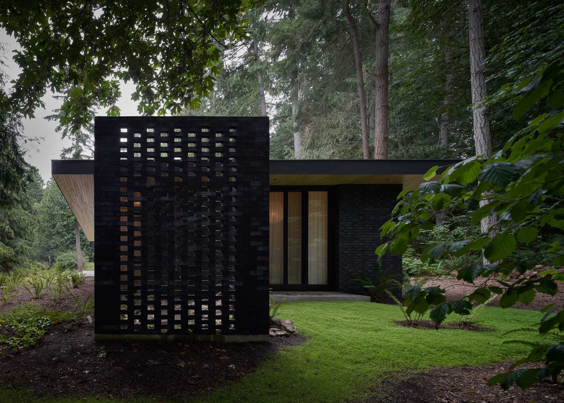 A modern home with dark brick exterior.