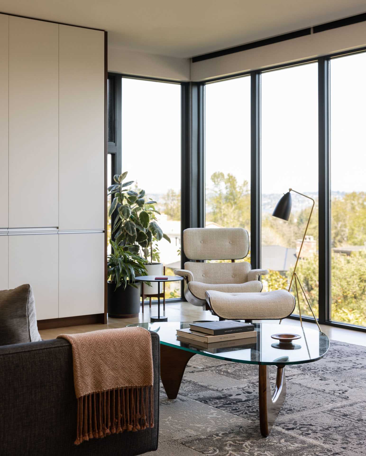 A modern living room with floor-to-ceiling windows.