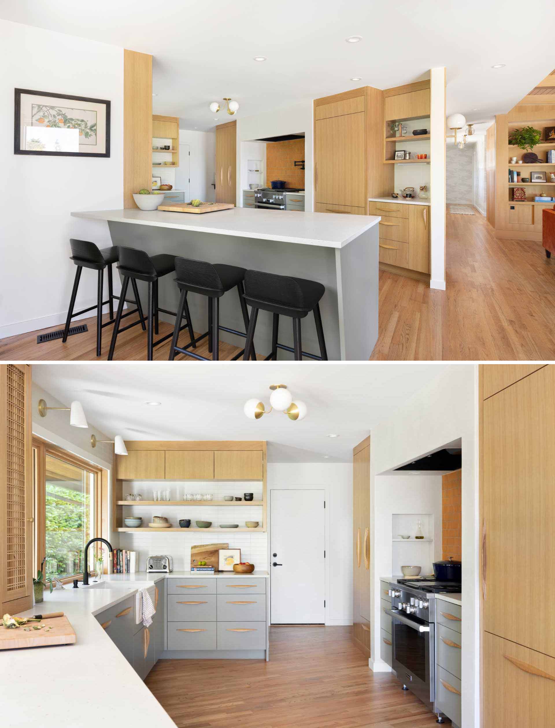 This new open kitchen includes a grey peninsula, grey cabinets, wood details, white countertops, and a tiled backsplash by the stove.