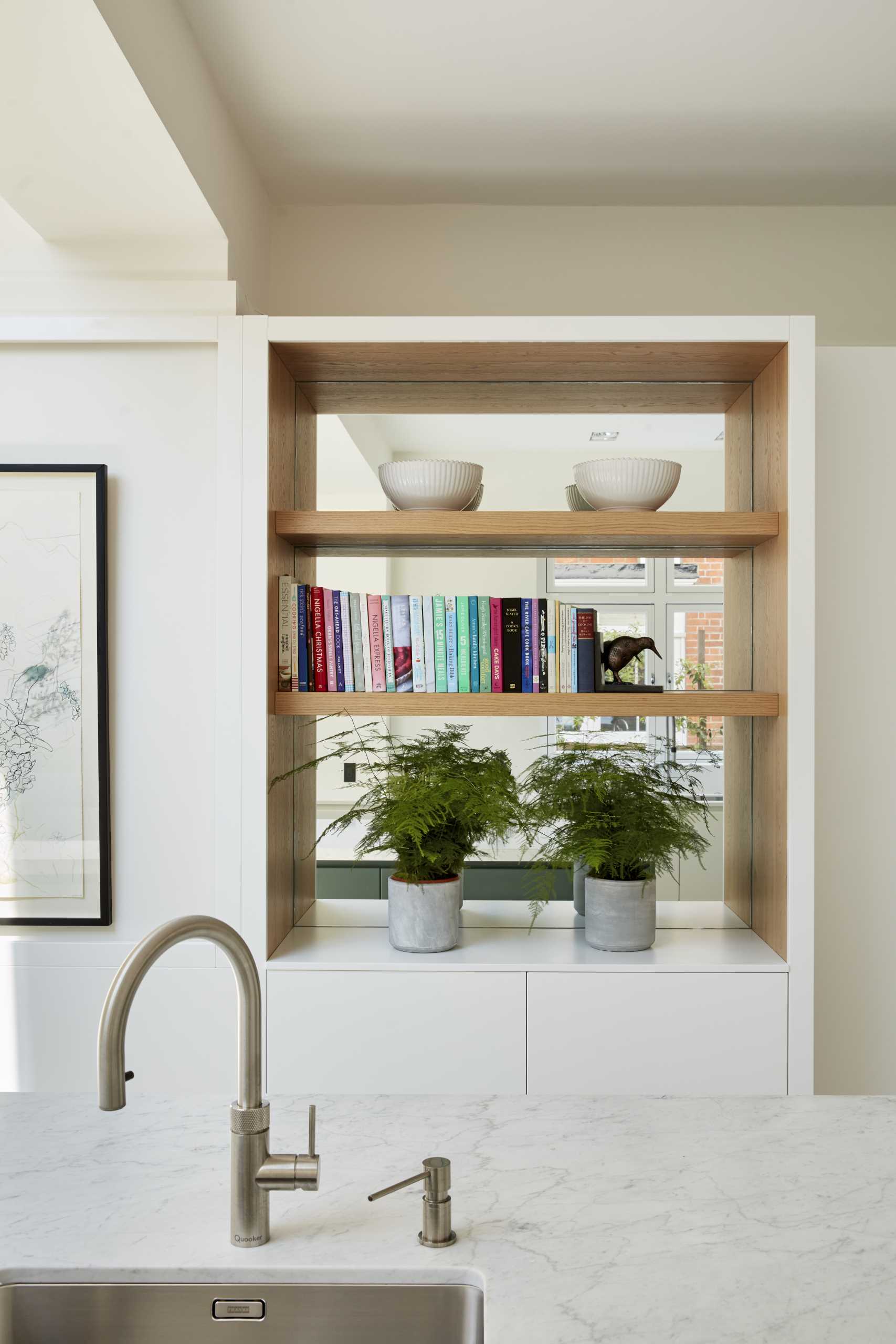 A mirrored built-in shelf creates the feeling of the space being larger than it is.