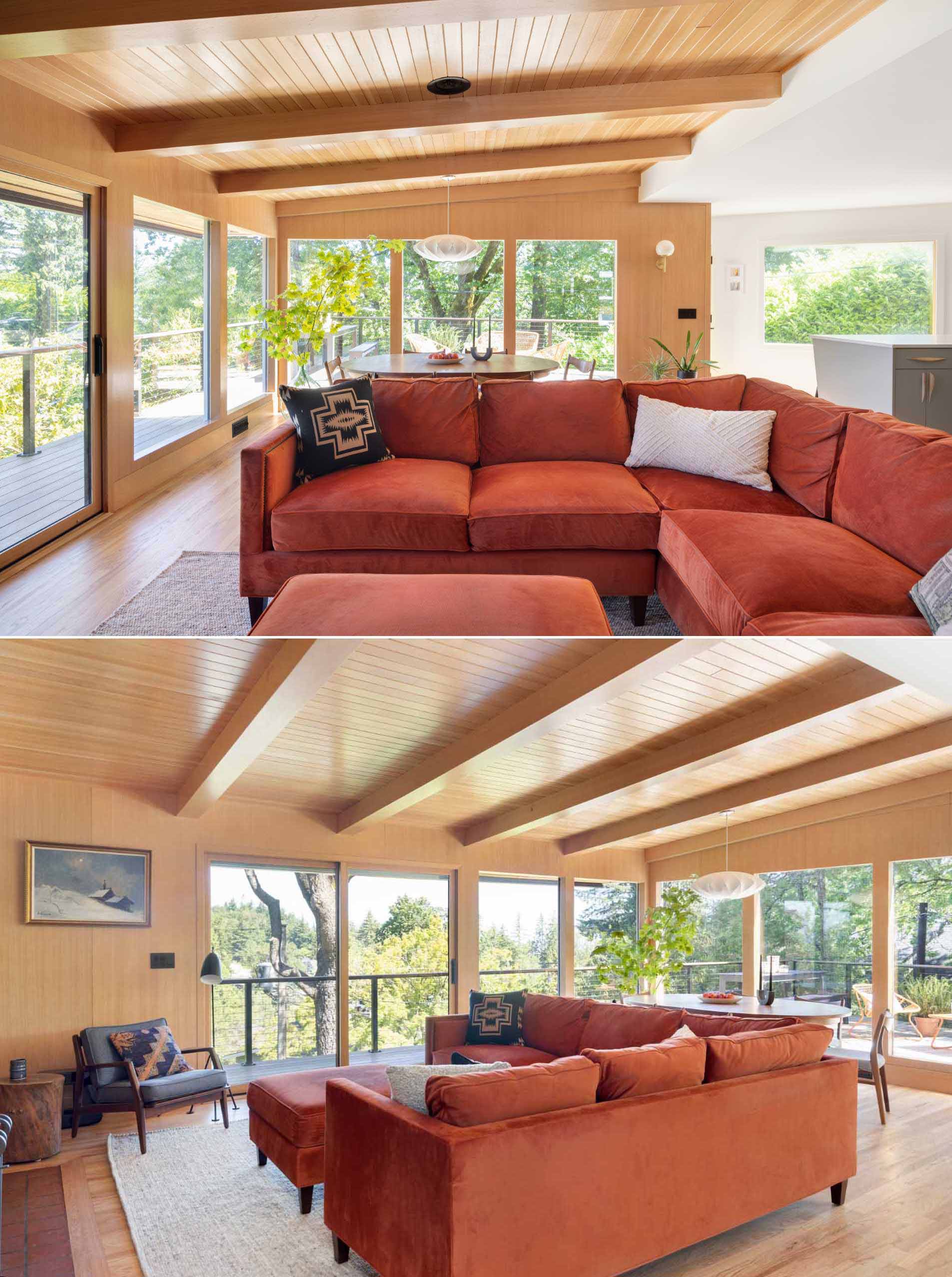 This updated living room received new wood floors as well as windows and doors. Throughout the home, the clients wanted to retain as many details as possible, like the beams in the ceiling.