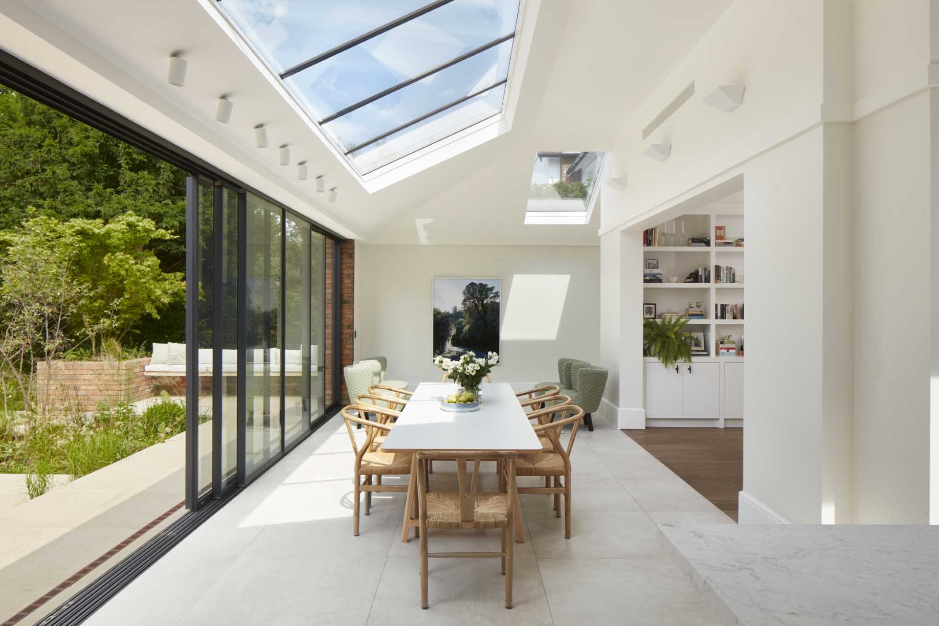 An updated brick extension for an Edwardian home includes a sitting area, dining area, and kitchen.